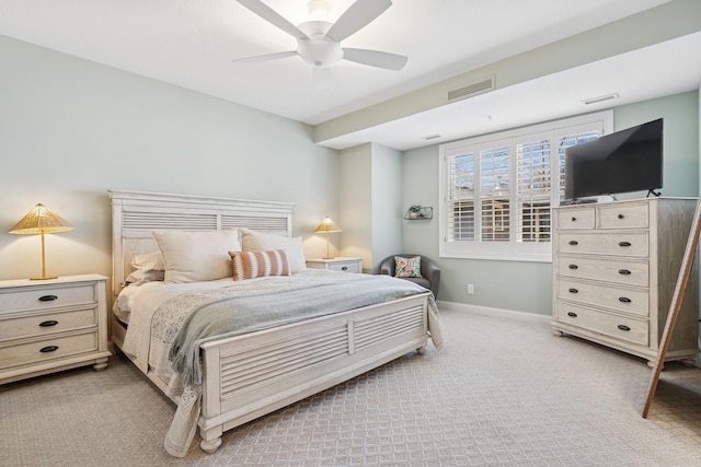 bedroom featuring ceiling fan, light colored carpet, visible vents, and baseboards