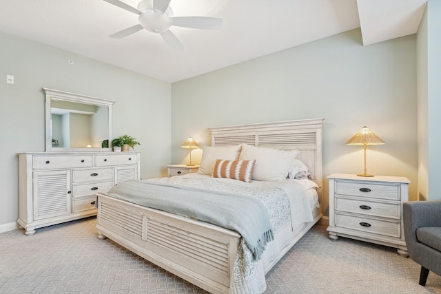 bedroom featuring light carpet, ceiling fan, and baseboards