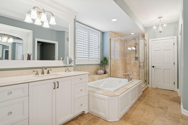 full bathroom featuring stone tile flooring, a stall shower, a bath, a notable chandelier, and vanity