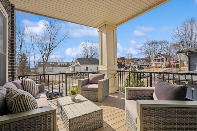 deck featuring a residential view and outdoor lounge area