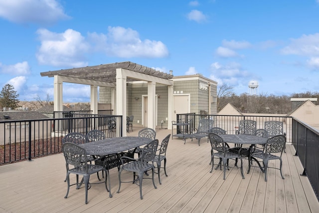 deck featuring outdoor dining space and a pergola