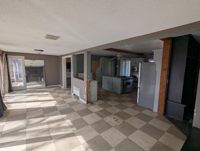 exterior space featuring a ceiling fan, open floor plan, appliances with stainless steel finishes, baseboards, and light floors