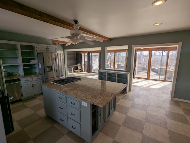 kitchen featuring a kitchen island, stainless steel appliances, a ceiling fan, and open shelves