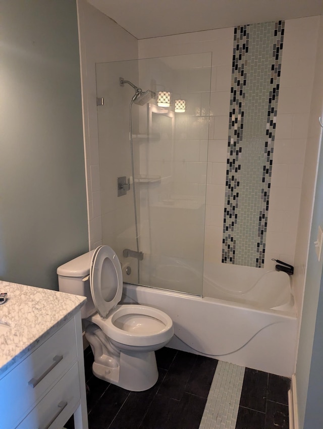 full bath with tile patterned floors, shower / washtub combination, vanity, and toilet