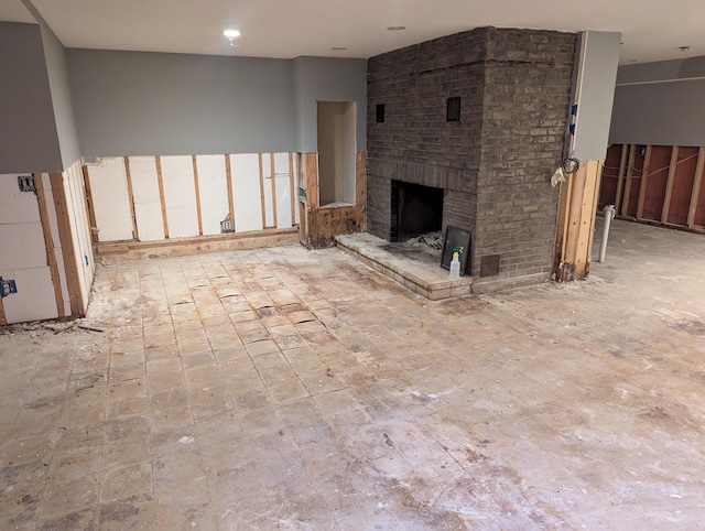 unfurnished living room featuring a brick fireplace