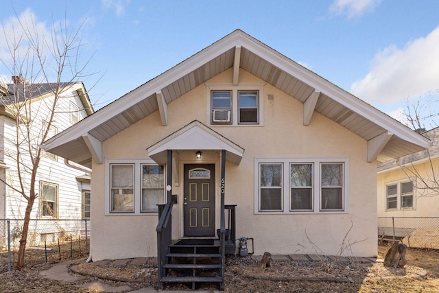 view of front of property with stucco siding and fence