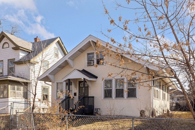 view of front facade featuring a fenced front yard and stucco siding