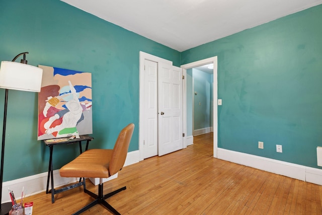 home office featuring hardwood / wood-style floors and baseboards