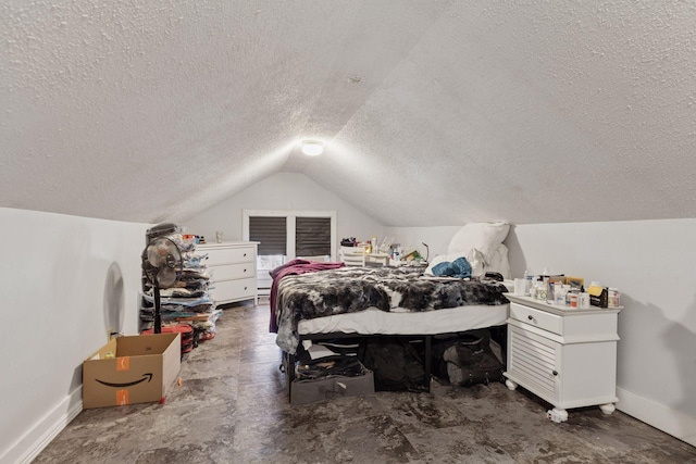 bedroom with vaulted ceiling, baseboards, and a textured ceiling