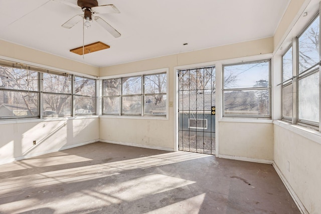 unfurnished sunroom featuring ceiling fan