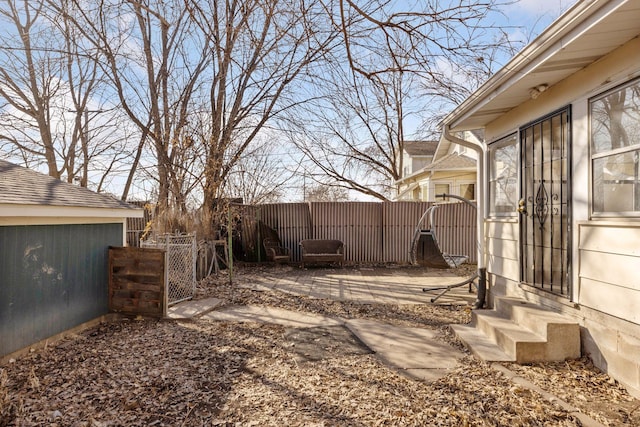 view of yard featuring entry steps, a gate, and fence