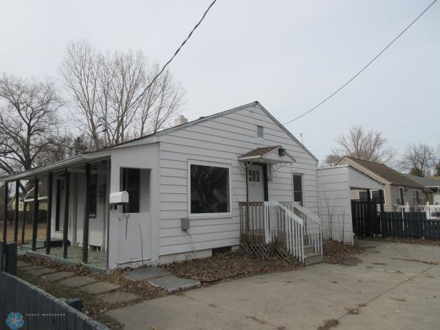 bungalow-style home featuring fence