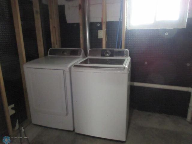 laundry area featuring laundry area, wood finished floors, and washing machine and dryer