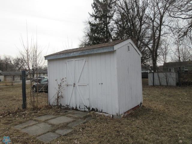 view of shed featuring fence