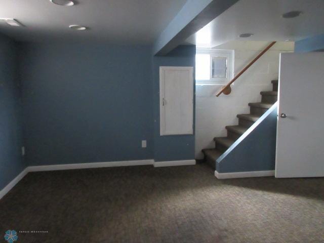 basement featuring carpet flooring, stairs, and baseboards