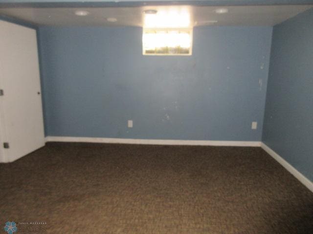 basement featuring baseboards and carpet floors