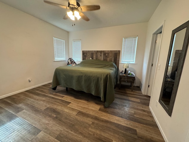 bedroom with ceiling fan, baseboards, and wood finished floors