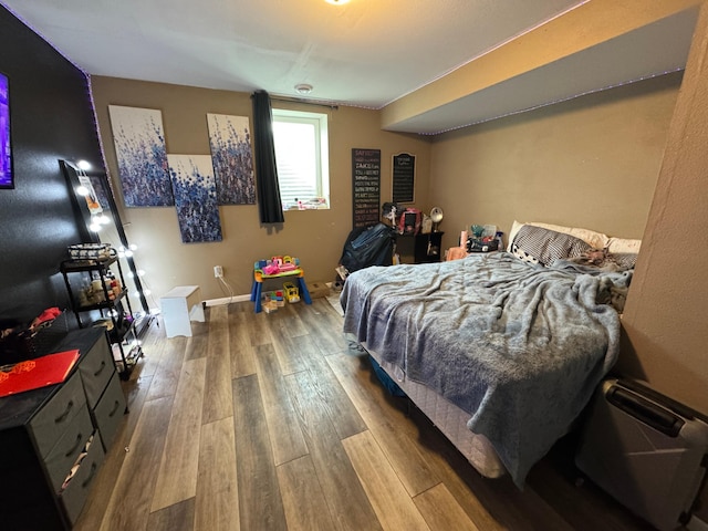 bedroom with hardwood / wood-style flooring