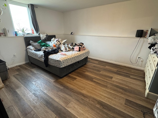 bedroom featuring dark wood-type flooring and baseboards