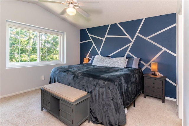 bedroom featuring ceiling fan, vaulted ceiling, baseboards, and light carpet