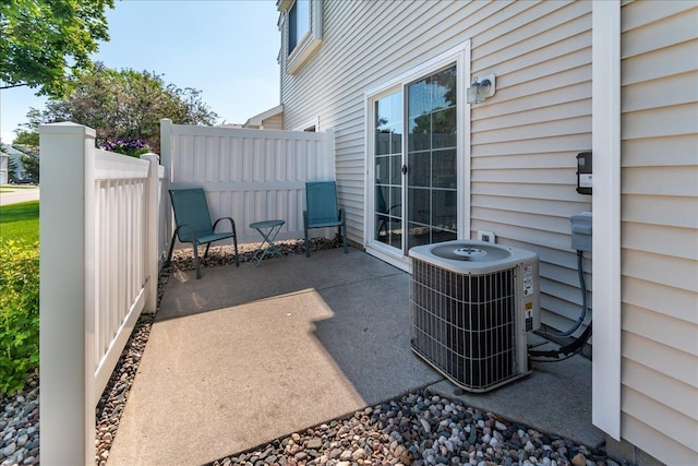 view of patio / terrace featuring central AC unit and fence