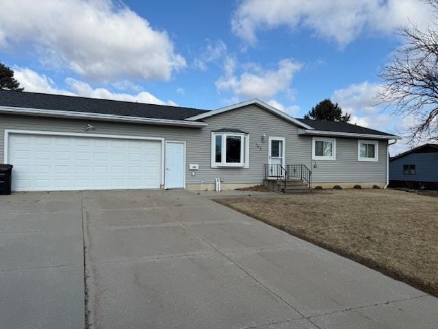 ranch-style house featuring concrete driveway and an attached garage