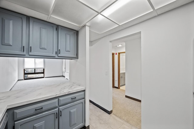 6400 York Ave S Unit 505, Edina, MN 55435 - kitchen with light colored carpet, baseboards, a drop ceiling, and gray cabinetry