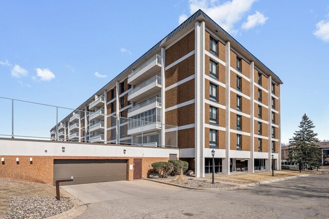 6400 York Ave S Unit 505, Edina, MN 55435 - view of building exterior featuring driveway and an attached garage