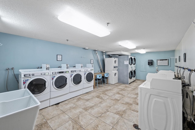 6400 York Ave S Unit 505, Edina, MN 55435 - community laundry room featuring a sink, a textured ceiling, stacked washer / drying machine, and washing machine and clothes dryer