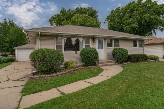 ranch-style home with a front lawn, a garage, and a shingled roof