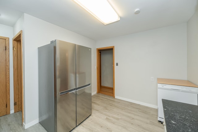 kitchen with baseboards, light wood finished floors, dishwasher, and freestanding refrigerator