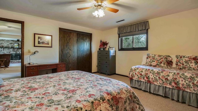 bedroom with a ceiling fan, light colored carpet, visible vents, and a closet