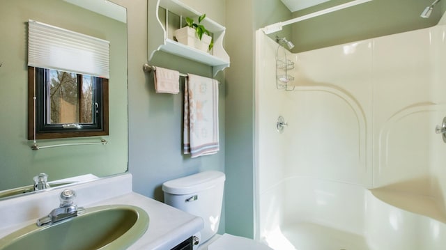 full bath featuring vanity, a shower stall, and toilet