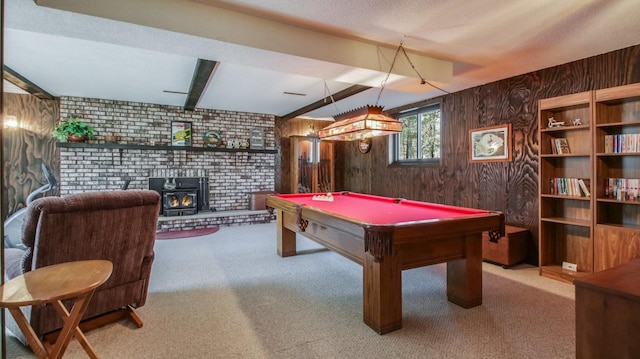 game room featuring beam ceiling, carpet, wood walls, and a textured ceiling