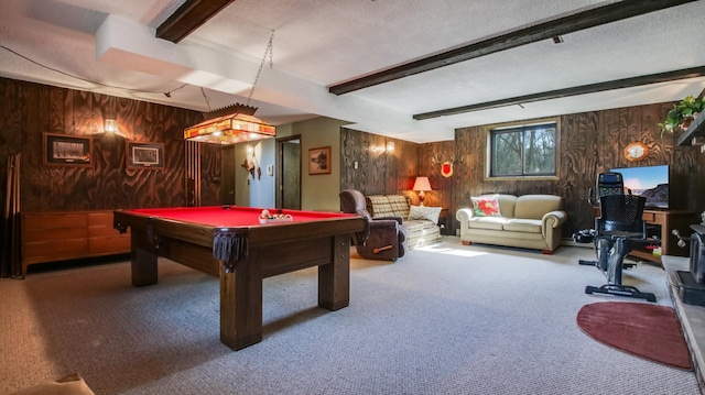 recreation room featuring beamed ceiling, wooden walls, and a textured ceiling