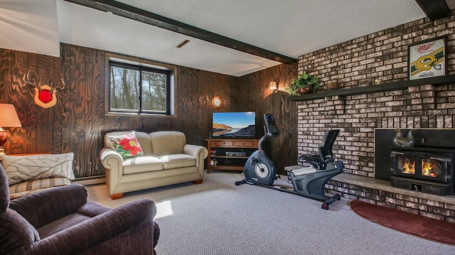 living room with carpet, a baseboard radiator, beam ceiling, a wood stove, and a textured ceiling