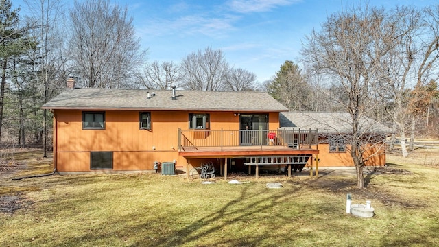 back of house featuring central AC unit, roof with shingles, a yard, a chimney, and a deck