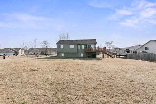 back of house with stairs, fence, and a wooden deck