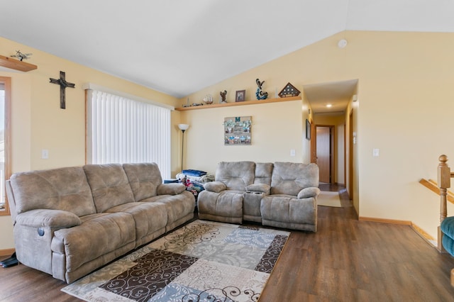 living room featuring wood finished floors, baseboards, and vaulted ceiling