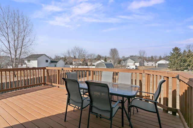 wooden terrace featuring outdoor dining area and a residential view