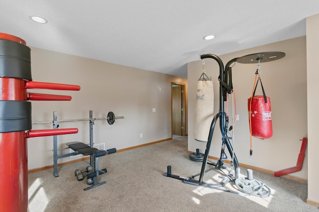 workout area featuring recessed lighting, baseboards, and carpet flooring