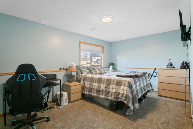 bedroom featuring a textured ceiling and carpet flooring