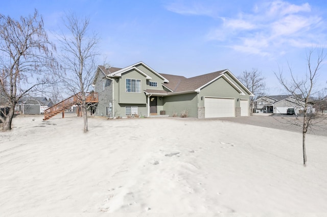 view of front of house featuring stairway and a garage