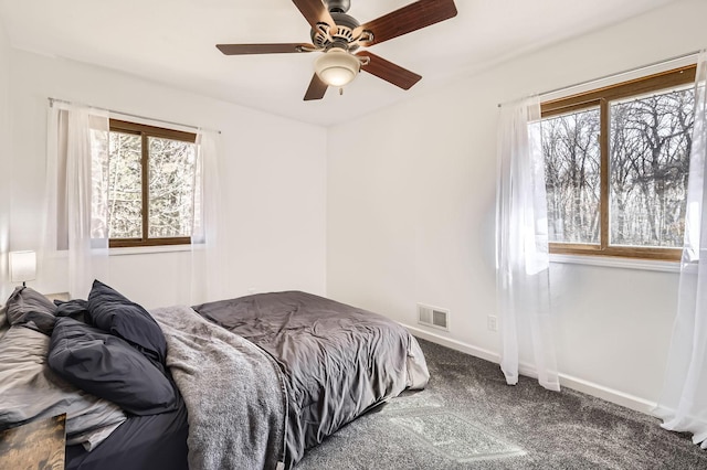 bedroom featuring carpet floors, baseboards, ceiling fan, and visible vents