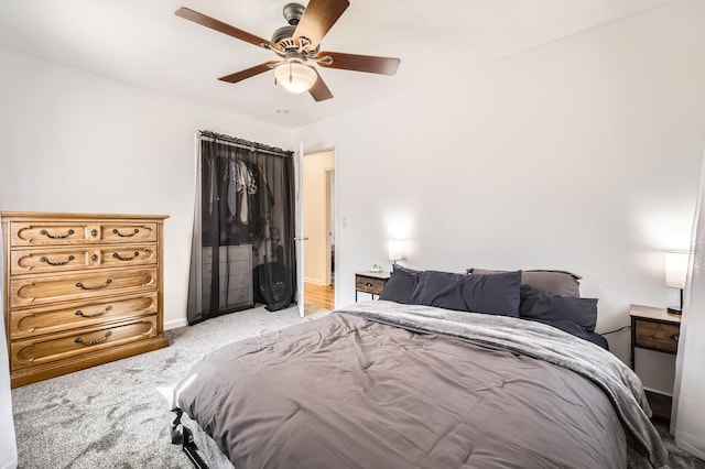 bedroom with light carpet, baseboards, and ceiling fan