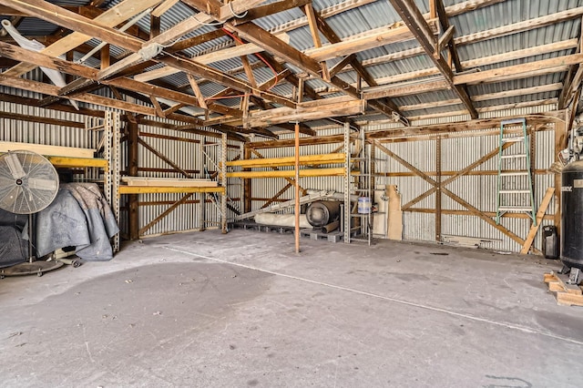 miscellaneous room with metal wall and concrete flooring