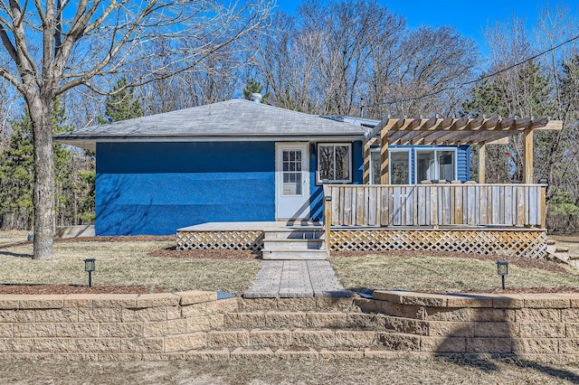 ranch-style house with a pergola and a wooden deck