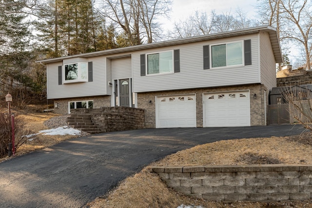 split foyer home with driveway and an attached garage