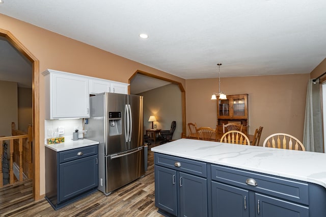 kitchen featuring blue cabinetry, stainless steel refrigerator with ice dispenser, and white cabinetry