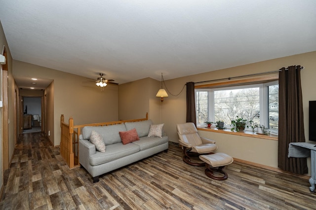 living room featuring a ceiling fan and wood finished floors